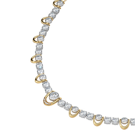Angled close up of round lab-grown diamonds set in alternating bezel and prong settings along a 14k yellow gold necklace chain