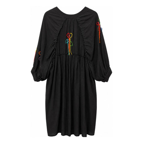 Back view of black shirt dress showing gathered waist and hand embroidered wildflower stitching in multiple colors