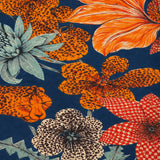 Close-up of the scarf's floral cluster in coral, cream, and dusty teal against the navy ground