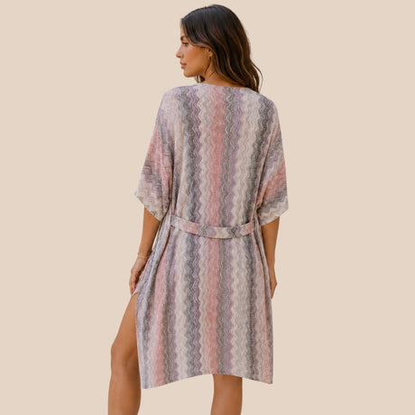 Back view of You & Eye pastel mauve chevron open-knit short kimono showing tied waist belt detail and side slits