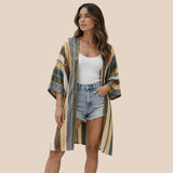 Front view of model wearing You & Eye sage chevron knit short kimono over denim shorts and white top