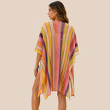 Back view of You & Eye vibrant yellow and pink chevron knit poncho showing open side slits and flowing drape