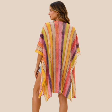 Back view of You & Eye vibrant yellow and pink chevron knit poncho showing open side slits and flowing drape