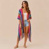 Front view of model wearing You & Eye vibrant pink chevron knit long kimono with fringe hem over denim shorts and white top